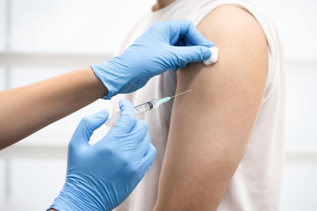 A man get Covid-19 vaccine at hospital. (select focus)