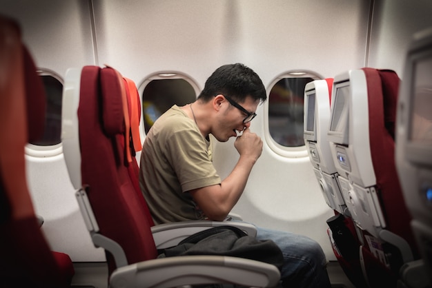Photo man get sick during travel on airplane, possibility of corona virus outbreak