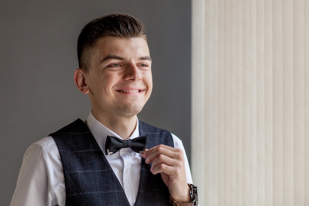 Man gets ready for work by buttoning up his business shirt.