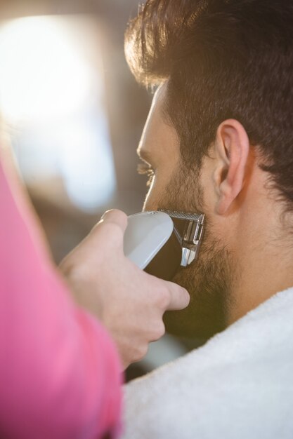 Man getting his beard trimmed