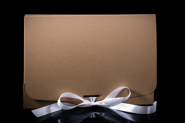 Man gift concept gift box with luxury bow on dark background Horizontal with copy space