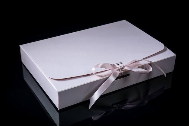 Man gift concept gift box with luxury bow on dark background Horizontal with copy space