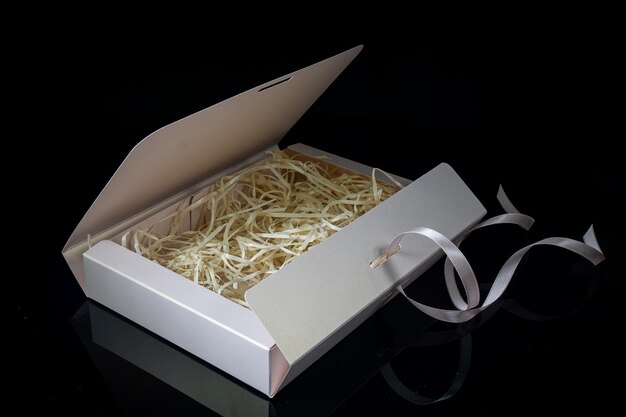 Man gift concept Open gift box with luxury bow on dark background Horizontal with copy space