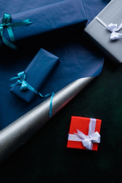 Man gifts on blue background Preparing for holidays and presents wrapping concept