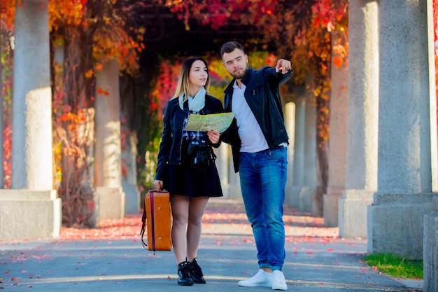 Man and girl help with navigation in the city for a tourist