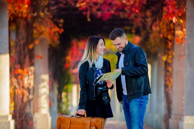 Man and girl help with navigation in the city for a tourist