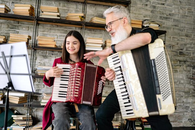 A man and a girl playing accordions