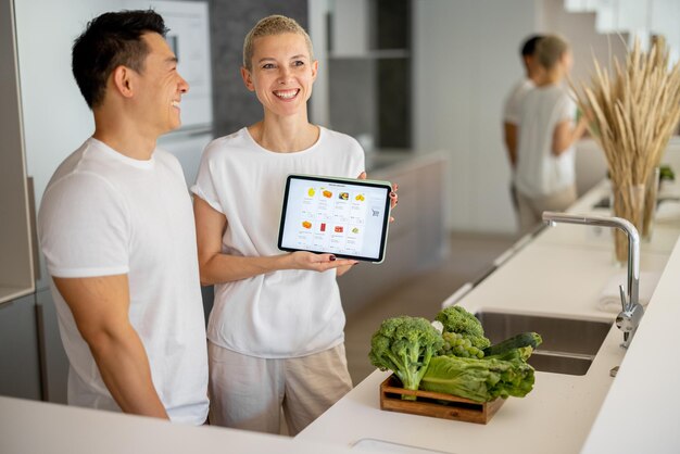 Man and girl show online food store on gadget