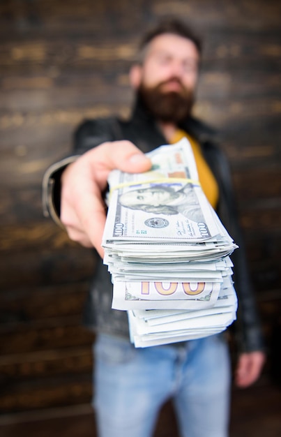 Man give cash money bribe richness and wellbeing mafia business\
man brutal bearded hipster wear leather jacket and hold cash money\
illegal profit and black cash guy mafia dealer with cash\
profit