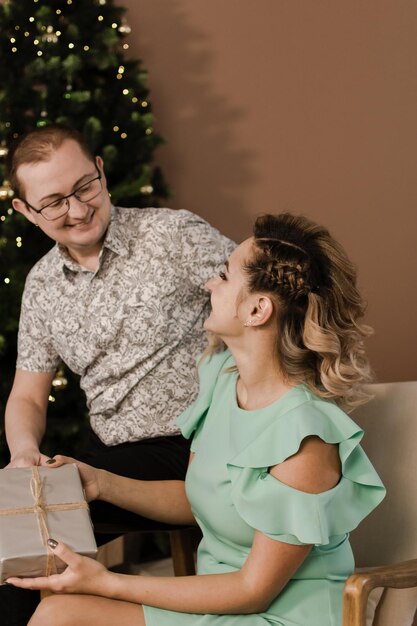 A man gives a gift to a woman for the new year