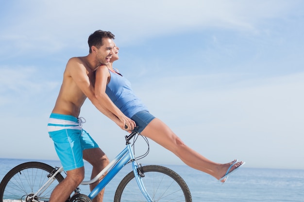 Man giving girlfriend a lift on his crossbar