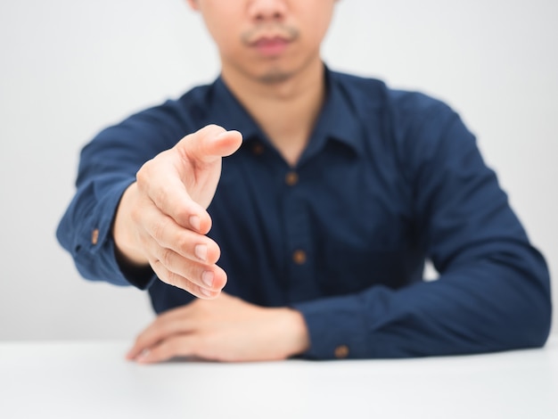 Man giving hand for handshake at the table