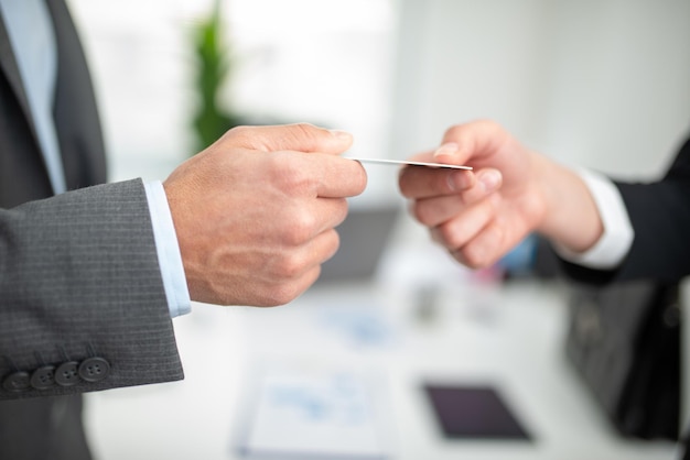 Man giving his business card to a woman