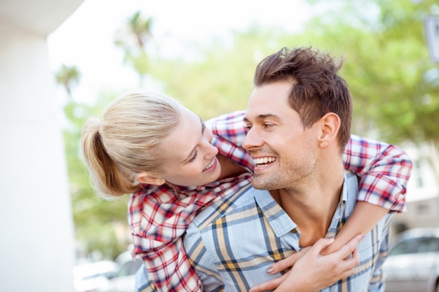 Man giving his pretty blonde girlfriend a piggy back