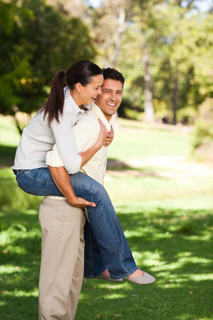 Man giving to his wife a piggyback