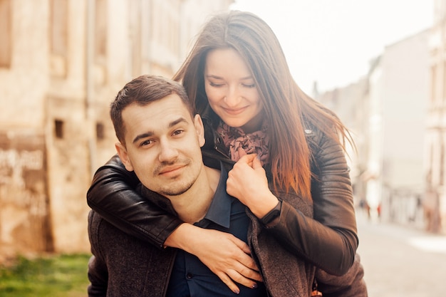 Man giving piggyback ride to his girlfriend