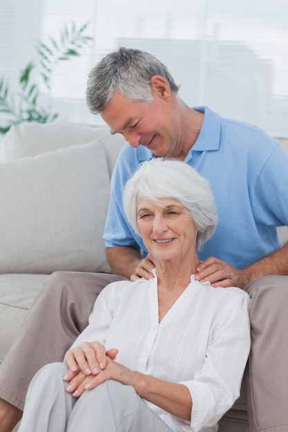 Man giving a shoulder massage to his wife