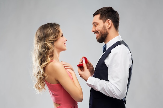 man giving woman engagement ring on valentines day