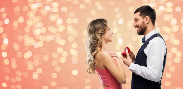 man giving woman engagement ring on valentines day