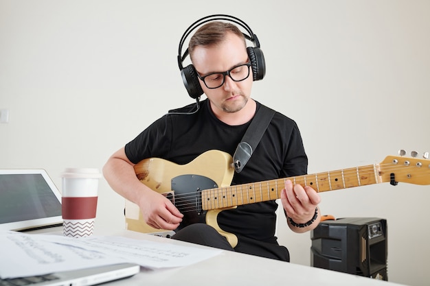 Man in glasses playing guitar