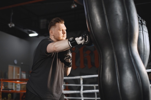 Man in a gloves. Boxer in a sport clothes. Guy with a beard.