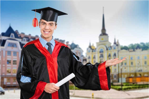 Man in graduation costume with diploma