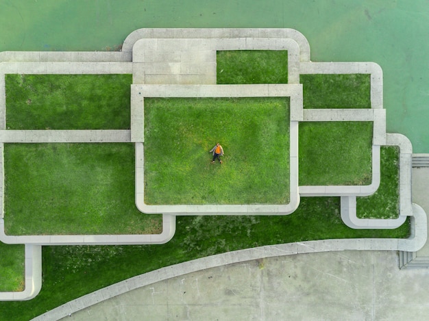 Man on the grass on top of the roof