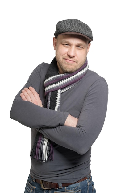 A man in a gray cap and gray scarf with arms folded Isolated