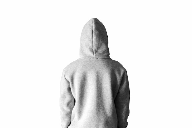 A man in a gray hoodie in a hood on a white background stands with his back