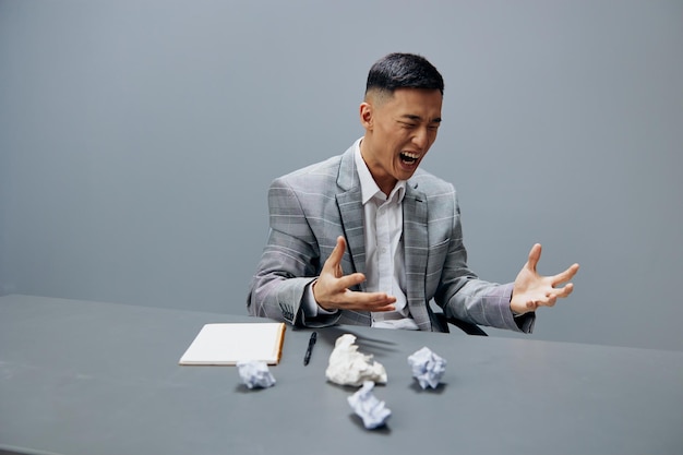 Man in a gray suit crumpled paper office official emotions\
isolated background