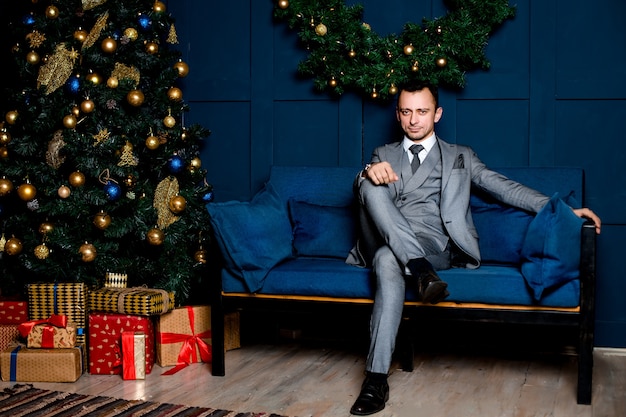 Man in a gray suit in the office on New year's eve.