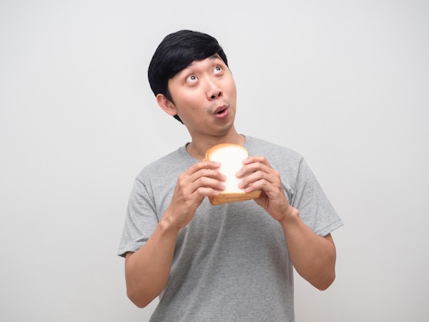 Man grey shirt holding bread feels excited looking up