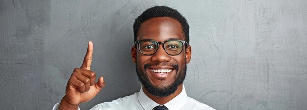man grinning confidently and pointing skyward a businessmans gesture suggests a course of action or concept to think about