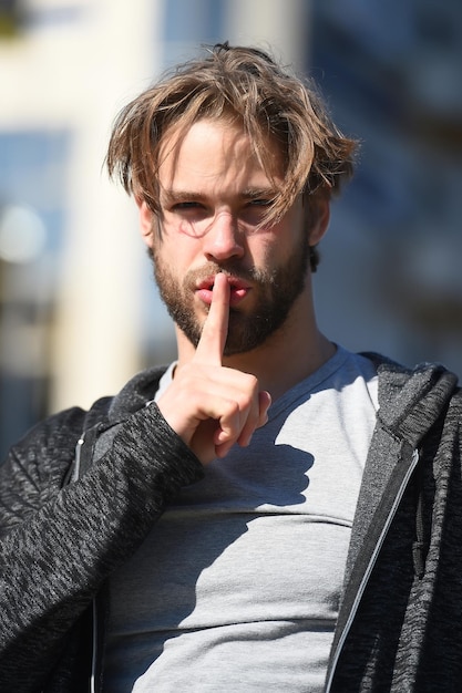 Man or guy with finger on lips gesture