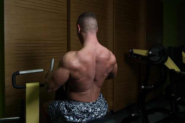 Man In The Gym Exercising Back On Machine