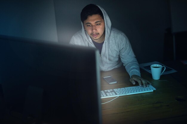 man hacker and tired with computer in night for programming software and working on project for system breach cybersecurity dark and network for media technology and online with user experience