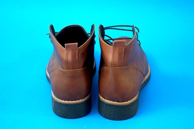 man half boots on a blue background