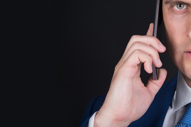 Man half face talking on smartphone