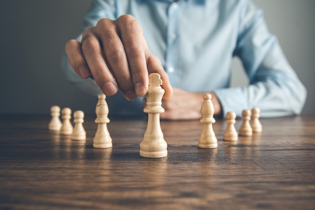 Man hand chess on table