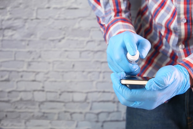 Man hand cleaning mobile phone display.