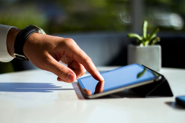 Man hand clicks on digital tablet closeup