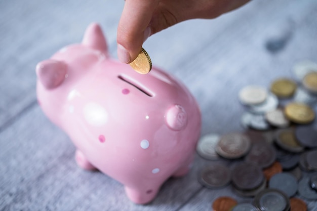 Man hand coin and piggy bank