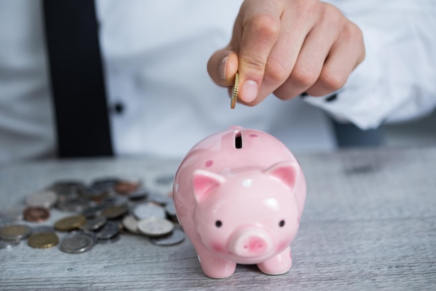 Man hand coins and piggy bank