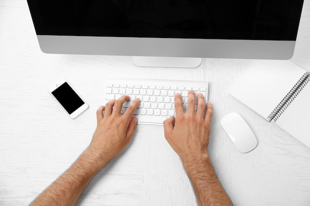 Man hand on computer keyboard on table top view