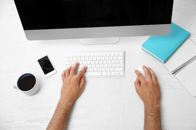 Man hand on computer keyboard on table top view