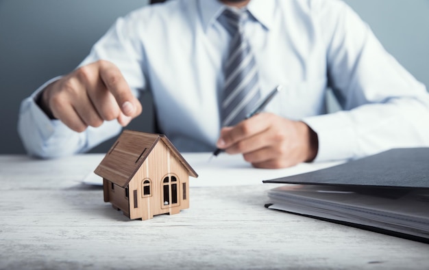 Man hand document with house model