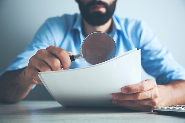 Man hand document with magnifier