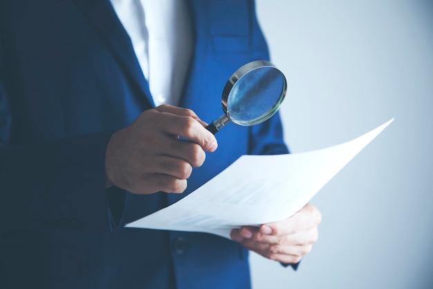 Man hand document with magnifier