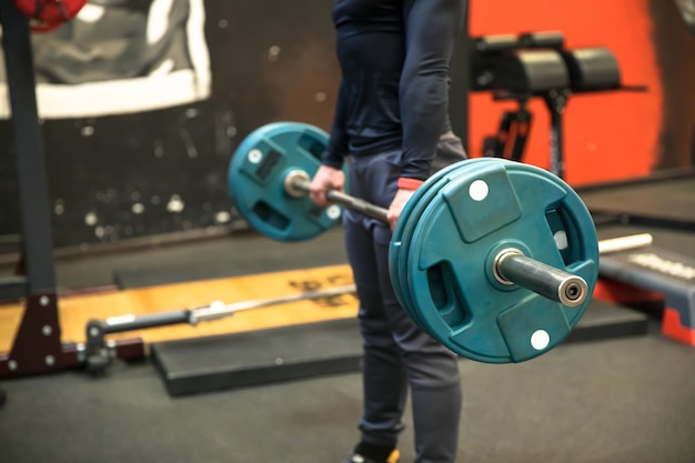 Man hand dumbbels in gym