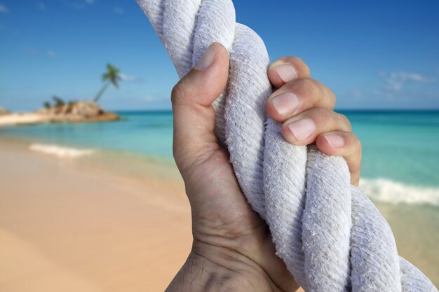 Man hand grab grip adventure paradise beach rope